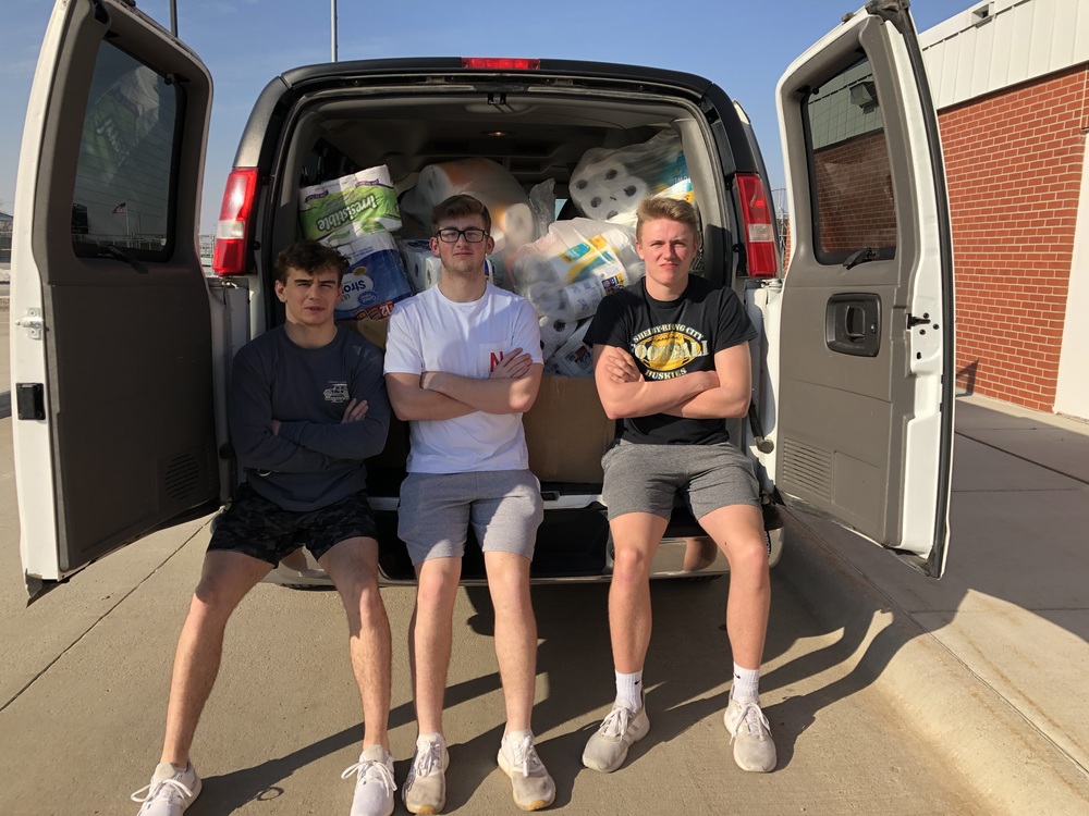 NHS students helping to pack the van were Grady Belt, Grant Brigham and Colin Wingard.